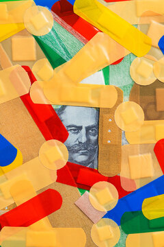 Australian dollar bill under first aid strips