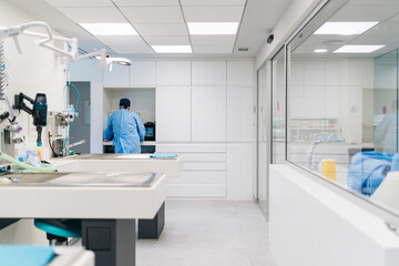 Veterinarian working in modern veterinary clinic operating room