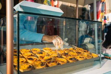 Freshly baked custard tarts in a bakery display