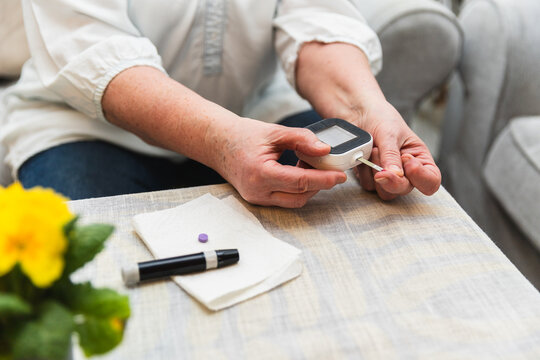 Senior woman checking blood sugar