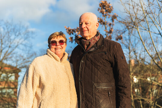 Senior couple enjoying sunny autumn weather outdoors