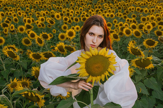 A girl holding a sunflower