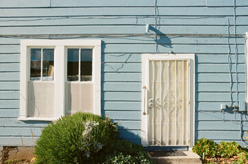 Blue Home with Security Screen Door