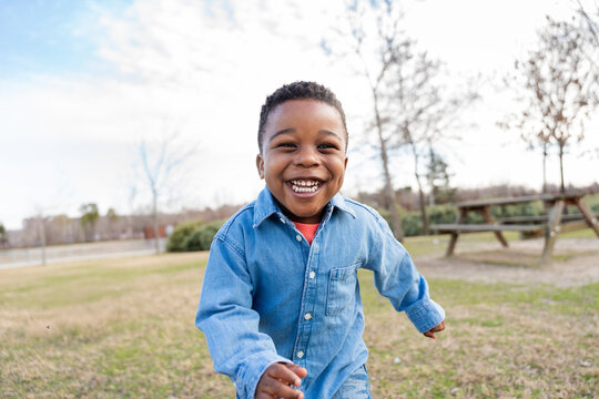Happy child running and smiling in a park