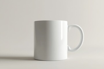 Obraz premium A white ceramic coffee mug is sitting on a plain surface