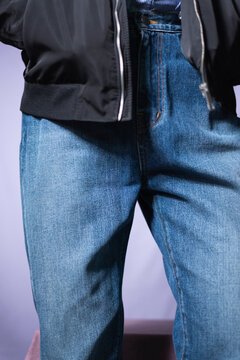 Man wearing jeans on the purple background