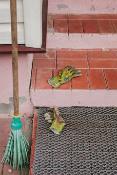 A broom and work gloves.