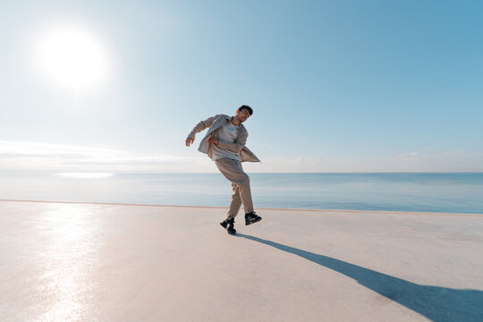Stylish urban dancer moving by the seaside