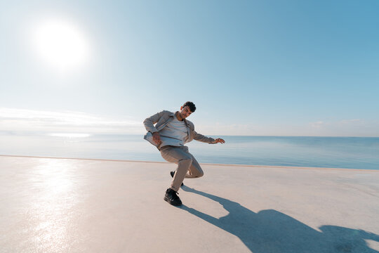 Stylish urban dancer moving by the seaside