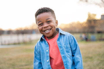 Portrait of happy african american child smiling outdoors in a park