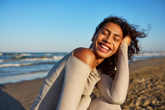Bright sunny day at the beach with a smiling young woman