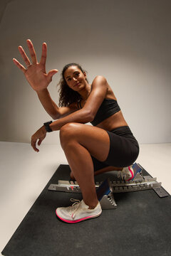 Athlete preparing for a sprint in a training studio