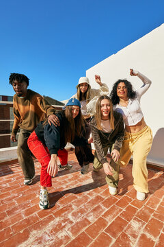 Group of friends enjoying a sunny day while dancing outdoors