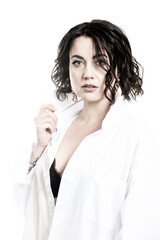 Portrait of a woman with dark hair, dressed in a white shirt, done in a high key.