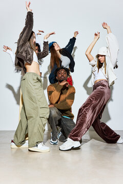 Women dancing around black man