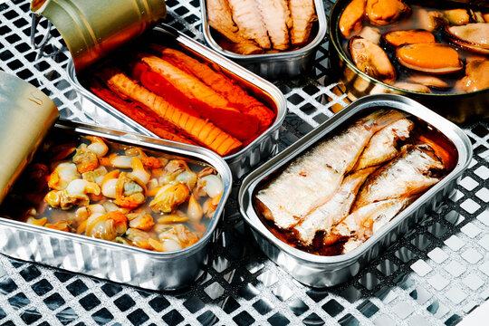 closeup of several open cans of tinned food