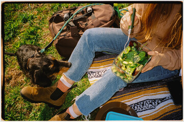 Flash-lit film shot of an unknown lady enjoying a salad with her dog