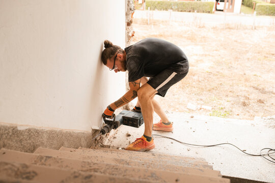 Construction Worker Using Power Tools for Home Renovation