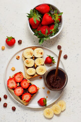Brioche slices with homemade Nutella, strawberries and bananas