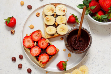 Brioche slices with homemade Nutella, strawberries and bananas