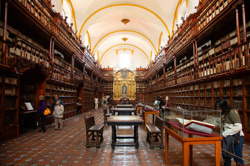Puebla, Mexico, January 1, 2025: The Palafoxiana Library with ancient books and wooden details from the 16th century.