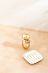 Copy space warm lighting background.Blank wallpaper with minimalist vase.Light and Shadow. Space for text.Backdrop.Studio photography.Sunshine. Chic style. Vase isolated on wooden. Home decor. Clean.