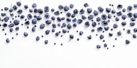 Soft blue petals scattered across a white surface create an elegant display for decor or craft projects