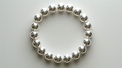 Obraz premium Elegant Silver Beaded Bracelet Arranged in a Circle on White Background Perfect for Jewelry Design or Fashion Blogs