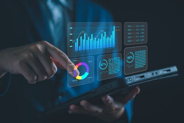 Analyzing Key Performance Indicators, Businessman using virtual screen to analyze key performance...