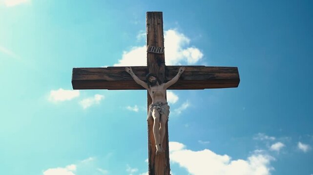 Crucifixion of Christ against the sky background. Catholicism, Christianity, faith concept. The initialism INRI Iesus Nazarenus, Rex Iudaeorum represents the Latin inscription in English translates to