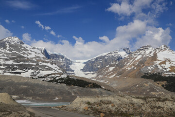 View of wide alpine basin surrounded by snowy peaks and glacier plateaus in Banff National Park,...