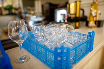 A blue tray with many glasses on it