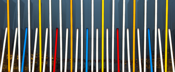 A series of neon colored lines are arranged in a row