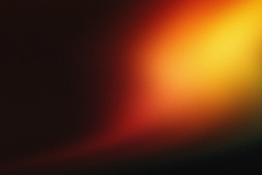 Abstract orange and red light leak on black background.