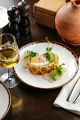 Layered pie with red fish and sauce