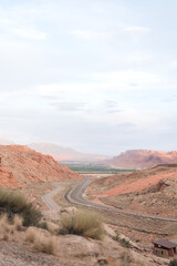 Serene Desert Road Leading to Majestic Red Rock Formations