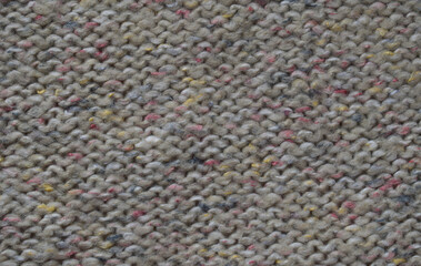 Macro shot of knitted woolen fabric with a rough woven pattern showcasing its intricate texture and...
