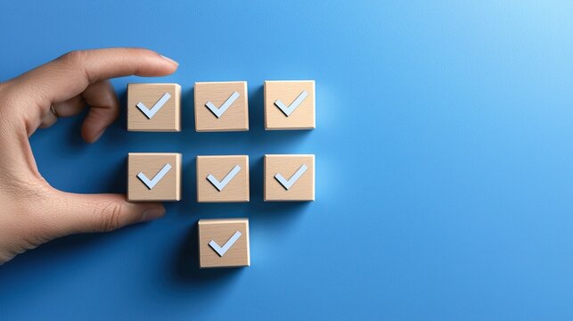 Productivity hacks, A hand is arranging wooden blocks with check marks on a blue background, symbolizing organization and task completion.