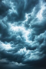 Dramatic stormy sky with dark clouds and bright light shining through creating a powerful atmosphere for weather photography