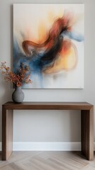 Colorful abstract painting displayed on a modern wooden console table with a decorative vase and dried flowers in a contemporary interior setting