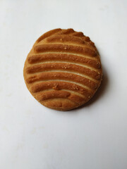 Round Whole Brown Color Biscuit and Cut Cookie isolated on white Background. Curve Shape pattern above the biscuit.