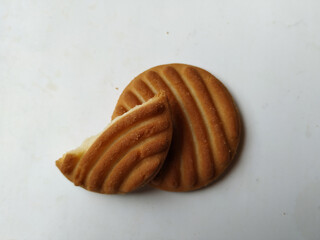 Round Whole Brown Color Biscuit and Cut Cookie isolated on white Background. Curve Shape pattern above the biscuit.