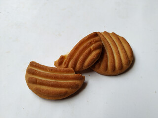 Round Whole Brown Color Biscuit and Cut Cookie isolated on white Background. Curve Shape pattern above the biscuit.