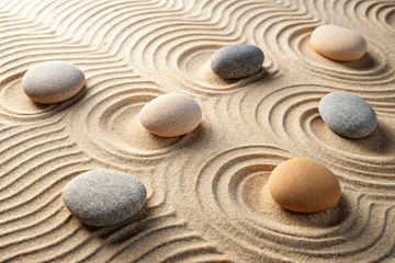 Use textured natural elements like fine sand or smooth river stones to create a Zen aesthetic