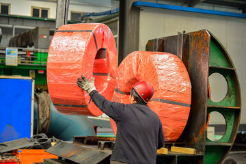 Workers on the production line of the strip steel coil factory are working