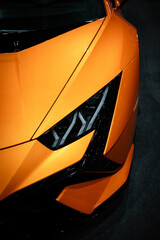 Headight of a orange car. Luxury car.