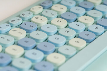 Close up of a modern computer keyboard with a cute, contemporary blue design seen from above.