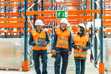 Warehouse workers checking inventory using barcode scanner and clipboard