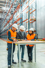 Warehouse workers and manager discussing logistics operations