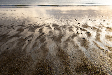 View of the sandy beach at low tide of Saint-Cast-Le-Guildo in summer in Côtes d'Armor, Brittany, France